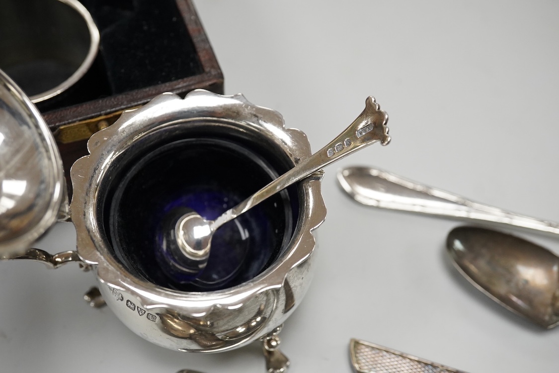 Three assorted 20th century silver napkin rings, a George V silver mustard pot and pepperette, a set of six late Victorian silver coffee spoons, London, 1883, and six other silver items.
